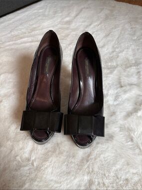 Patent Peep-Toe Heels with Bow Accent in eggplant color.